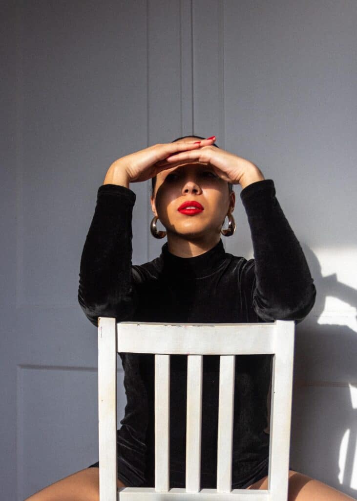 Kelsey Vaz sits in a neutral position on a chair